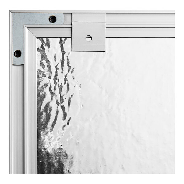 A close-up of a Quartet cork board with a silver aluminum frame.