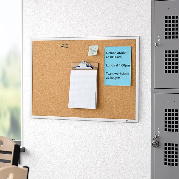 A Quartet cork board with a silver aluminum frame.