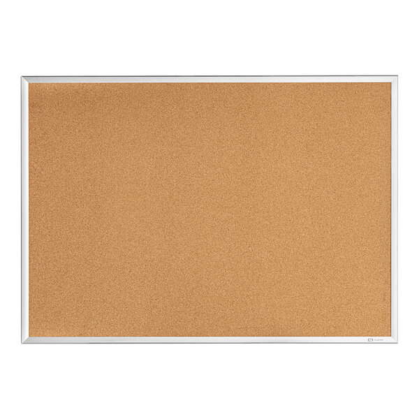 A Quartet cork board with a silver frame.