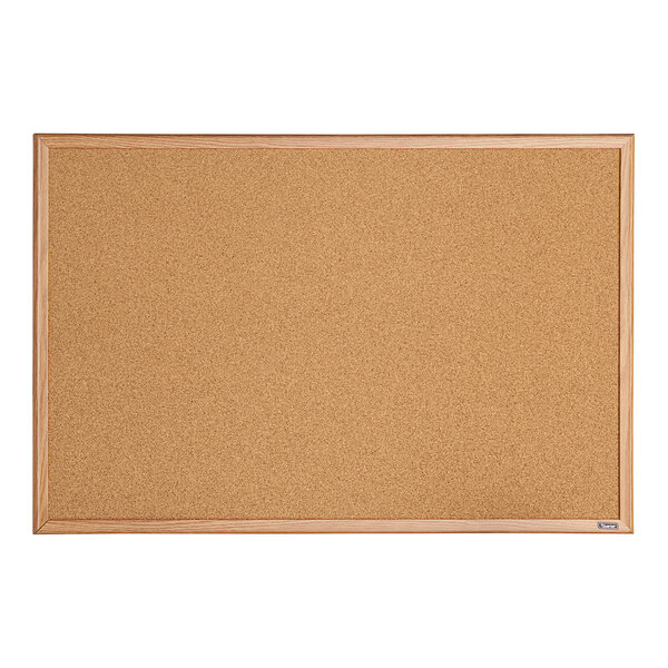 A Quartet cork board with an oak frame.