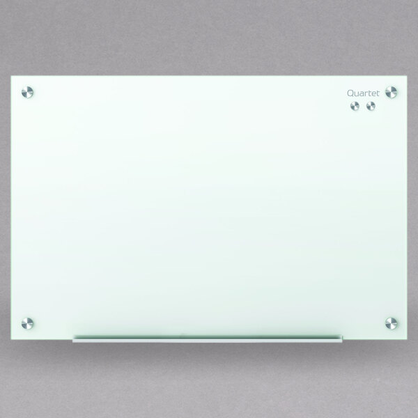 A Quartet frameless white glass markerboard.