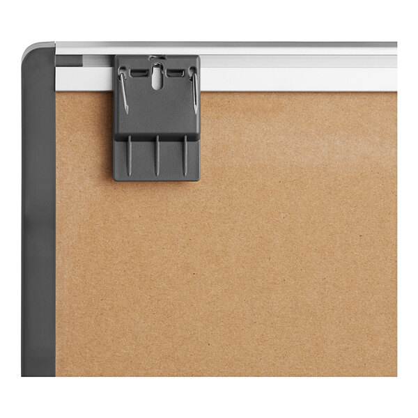 A close up of a Quartet magnetic whiteboard with a silver aluminum frame.