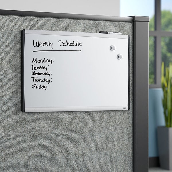 A Quartet magnetic steel whiteboard with black writing on it.