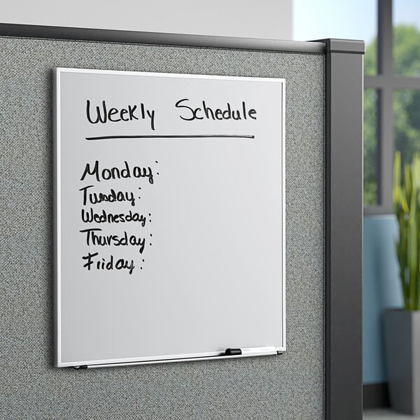 A white Quartet whiteboard with a schedule in black text.