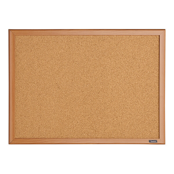 A Quartet cork board with an oak finish wooden frame.