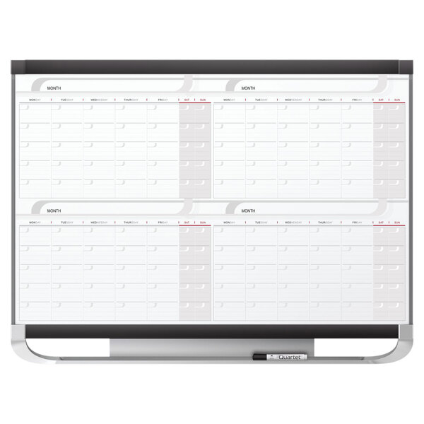 A white Quartet Total Erase whiteboard with a calendar.