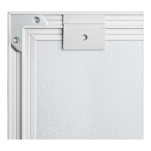 A close-up of the silver aluminum corner of a Quartet Matrix whiteboard.