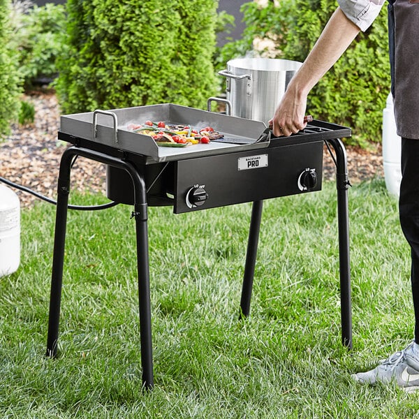 man uses an outdoor griddle