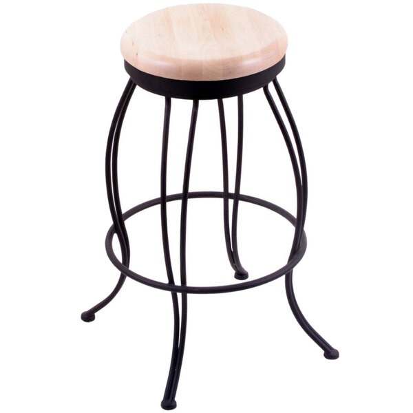 A Holland Bar Stool black steel swivel stool with a natural maple wood seat.