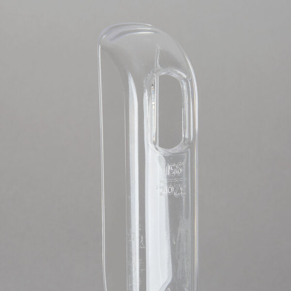 A clear plastic container with a clear plastic scoop inside.