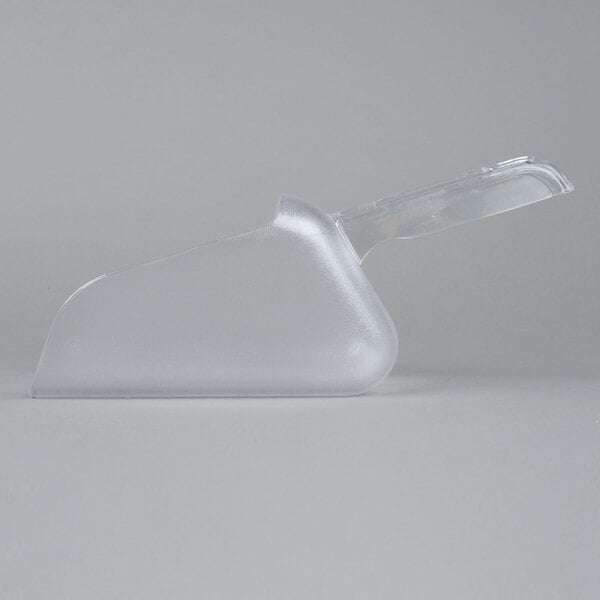 A clear plastic Rubbermaid Bouncer scoop on a white surface.