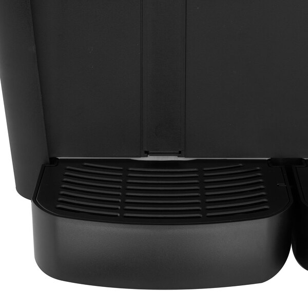 A black Crathco beverage dispenser with two compartments on a counter.