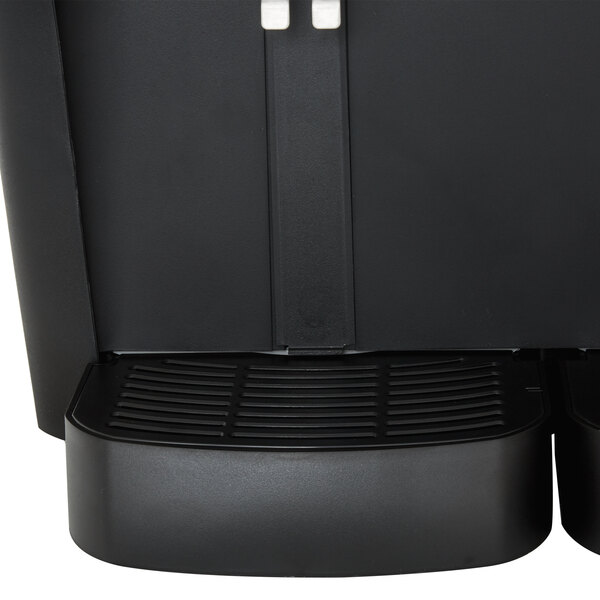 A black Crathco refrigerated beverage dispenser with two compartments on a black surface.