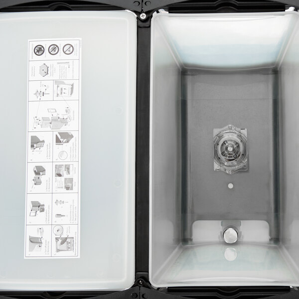 A Crathco refrigerated beverage dispenser with a plastic container and a lid with a fruit decal.