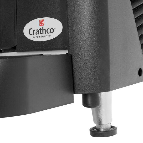 A Crathco refrigerated beverage dispenser with a black base and fruit decal.