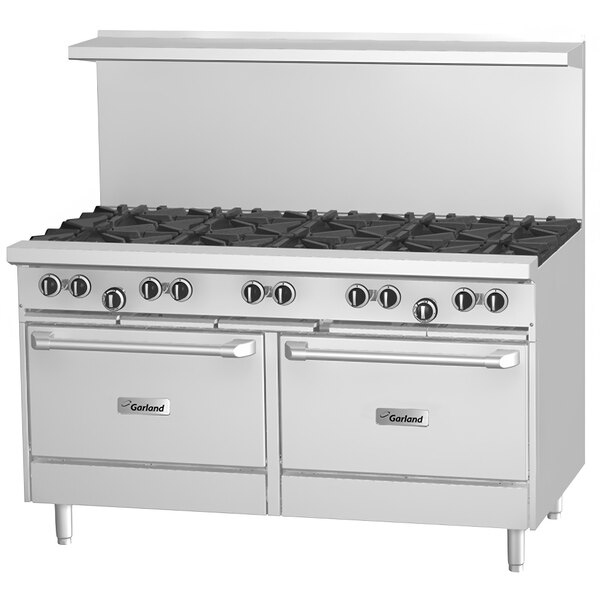 A large stainless steel Garland gas range with a griddle, oven, and storage base.