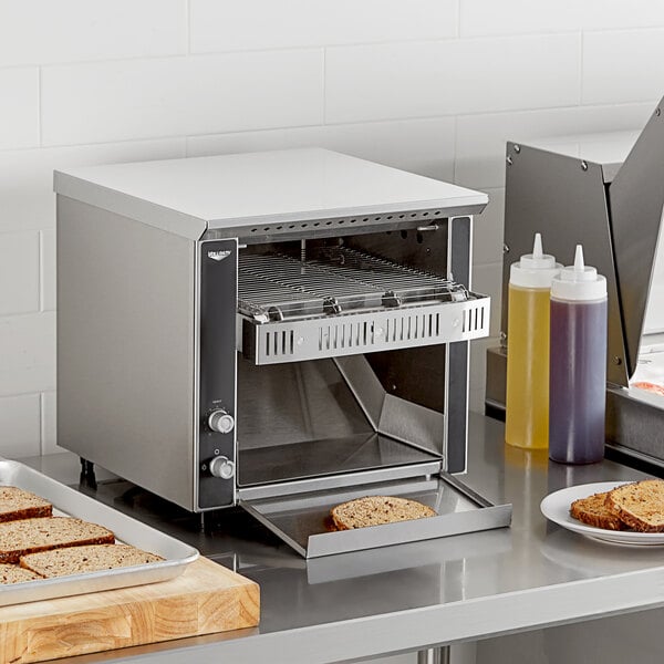 A Vollrath conveyor toaster with bread on a tray.