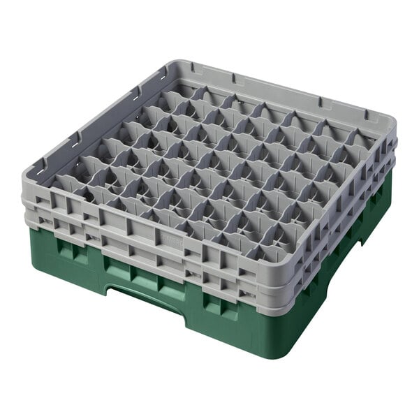 A green and gray plastic Cambro glass rack with many compartments inside.