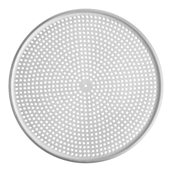 A white round metal pizza screen with holes.