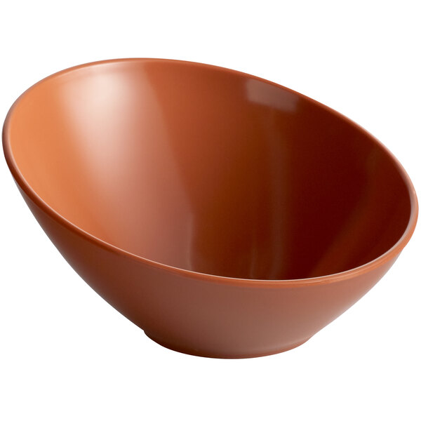 A brown slanted melamine bowl with a pumpkin design.