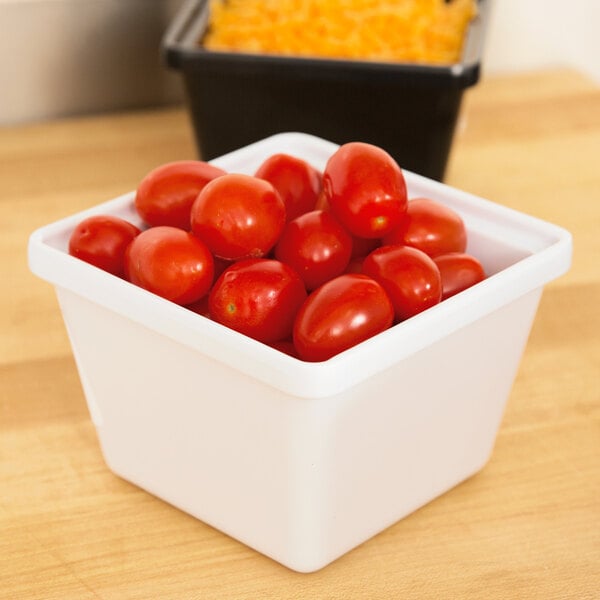 A white square melamine crock filled with cherry tomatoes.