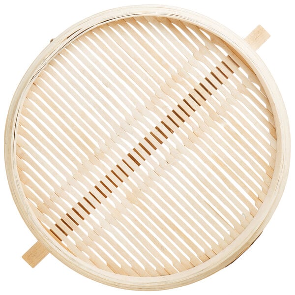 A round bamboo steamer with wooden handles.