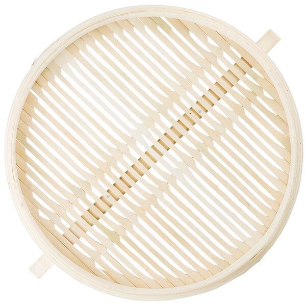 A Town bamboo steamer basket with handles.