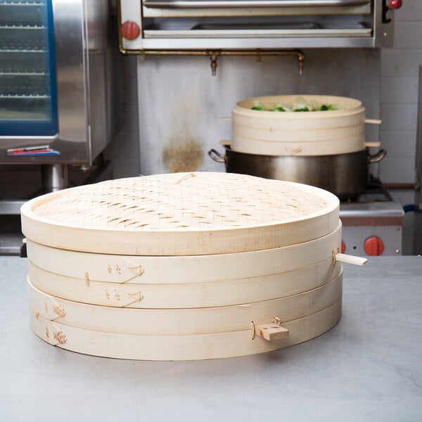 A stack of Town Bamboo Steamer Sets on a counter.