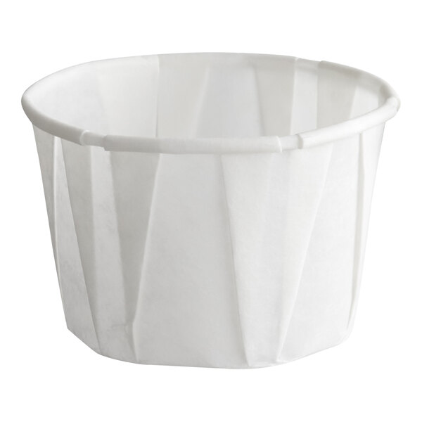 A small white paper souffle or portion cup with a 1.25 oz. capacity.