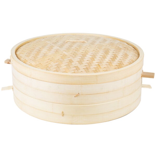 A round bamboo steamer with handles and a lid.