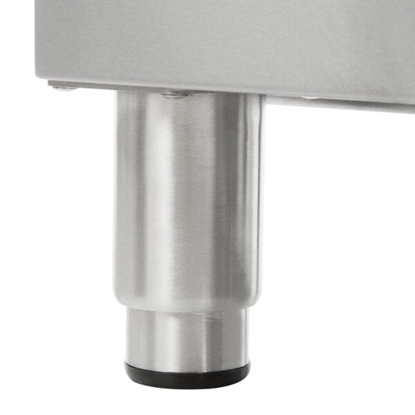 A close-up of a Globe countertop gas hot plate with a metal leg.