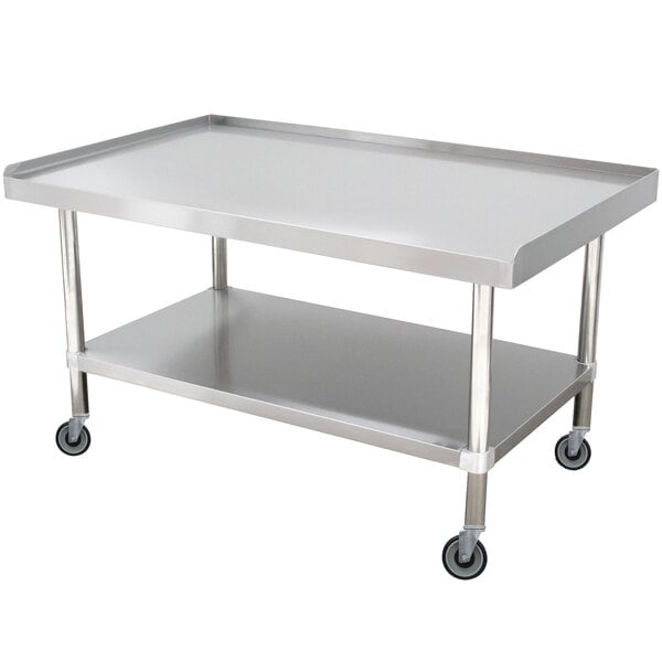 A stainless steel table with wheels.