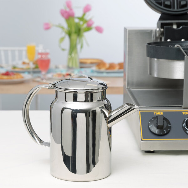 A stainless steel Vollrath batter dispenser on a counter.