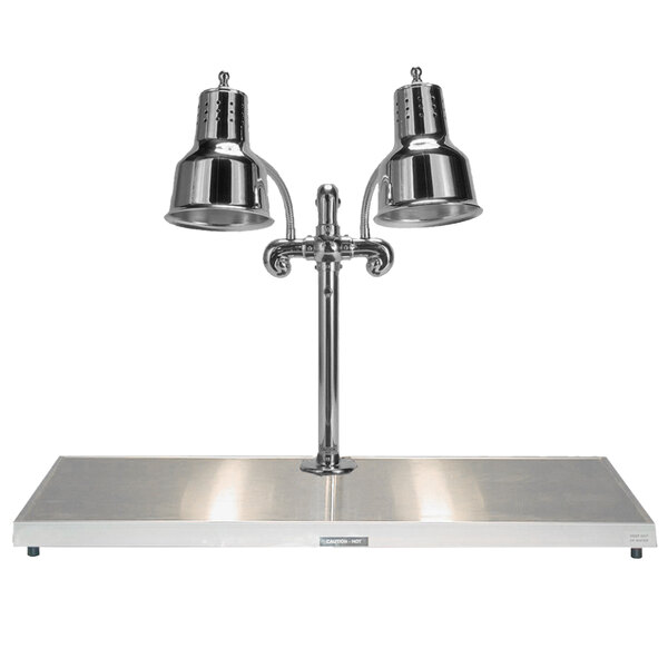 A Hanson Heat Lamps chrome carving station with two lamps over a metal surface.