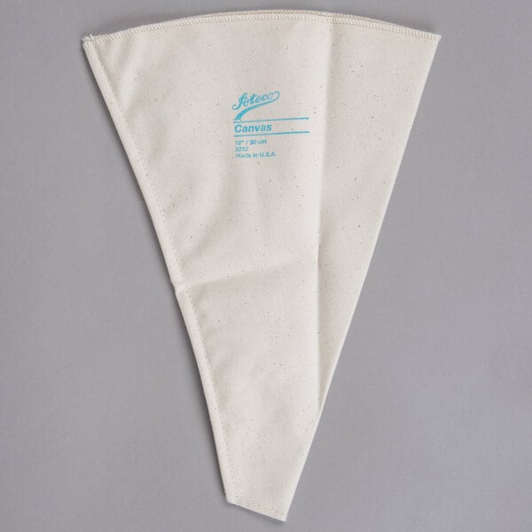 A white triangular canvas bag with blue writing on it.