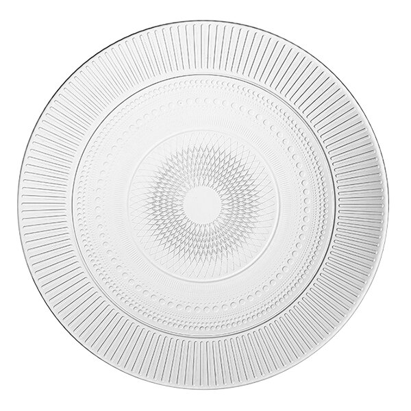 An Arcoroc glass dinner plate with a circular design on it.