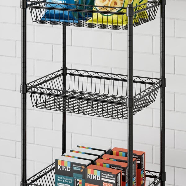 A Regency black metal shelf with baskets holding food and boxes.