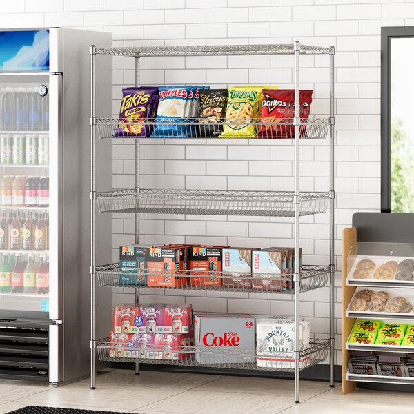 A Regency wire shelving unit with baskets and a shelf holding snacks and drinks in a convenience store.