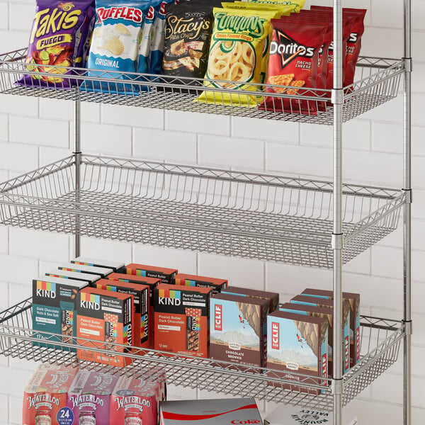 A Regency metal shelf with snacks in baskets.