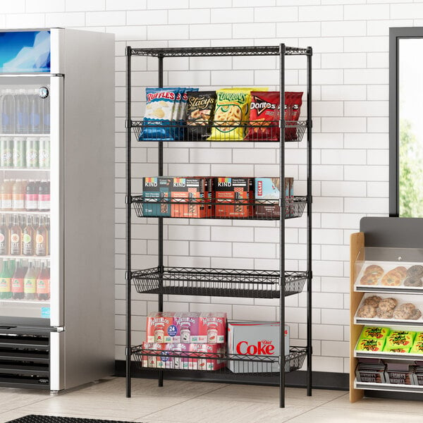 Regency black wire shelving with baskets and a shelf holding snacks and drinks in a convenience store.