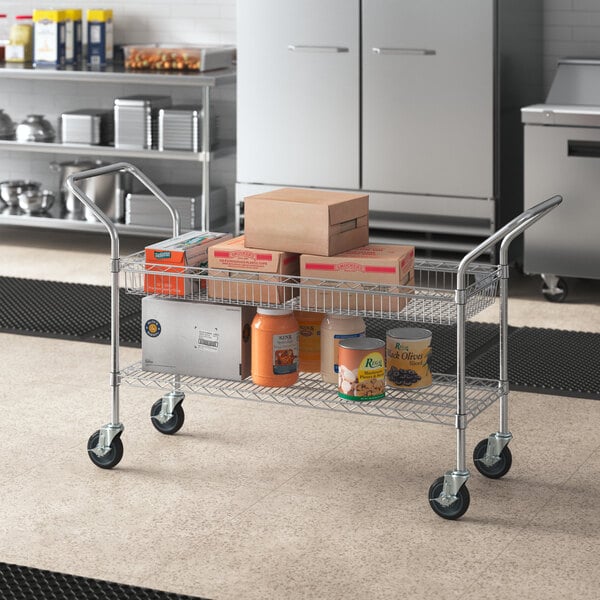 A Regency chrome utility cart with a shelf and basket holding boxes.