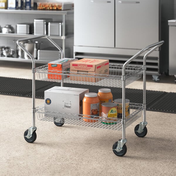 A Regency chrome utility cart with two wire baskets holding food and drinks.