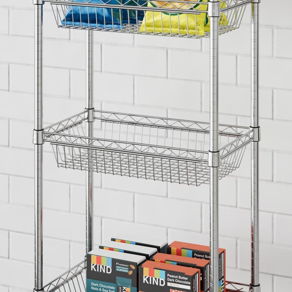 A Regency chrome wire shelf basket on a shelf filled with food.