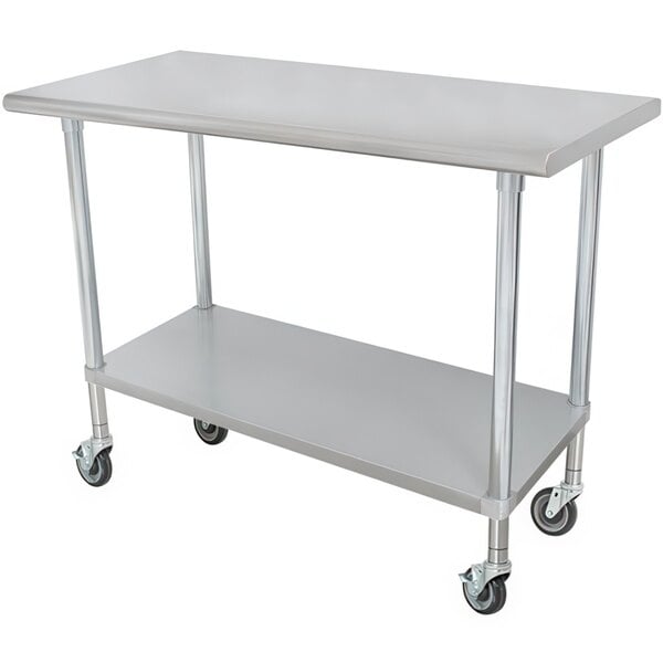 An Advance Tabco stainless steel work table with casters and a galvanized undershelf.