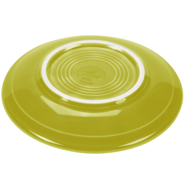A lemongrass yellow saucer with a white rim.
