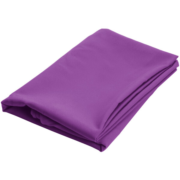 A close-up of a purple folded cloth with a hemmed edge.