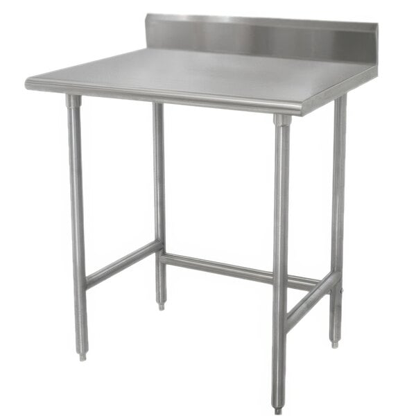 A stainless steel Advance Tabco work table with backsplash and galvanized legs.