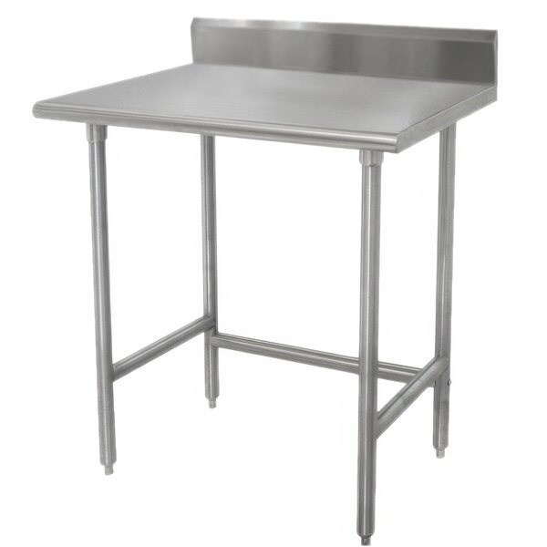 An Advance Tabco stainless steel work table with backsplash on a counter.