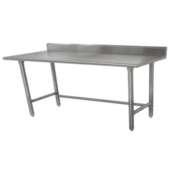 A stainless steel Advance Tabco work table with a backsplash on a white surface.