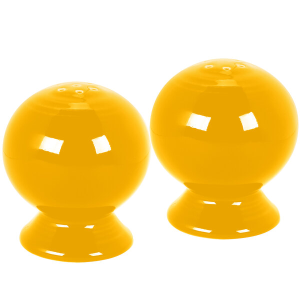 A pair of yellow salt and pepper shakers.
